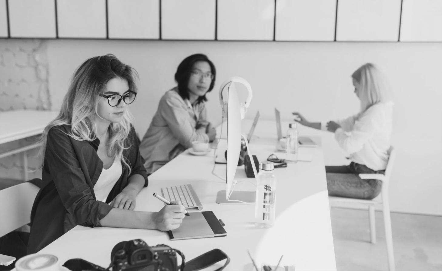 Students collaborating on budget analysis project with charts and financial documents